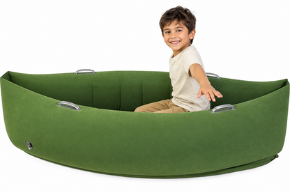Child in beige shirt in green sensory peapod