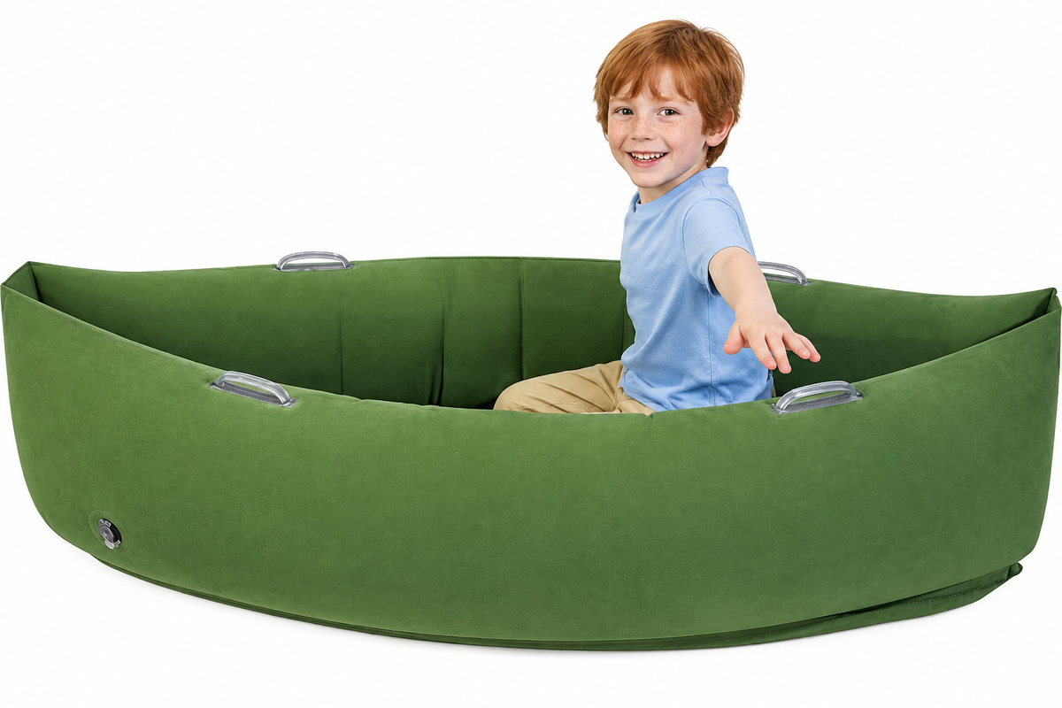 Child in blue shirt in green sensory peapod