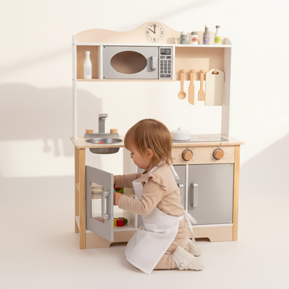 Child placing food in oven