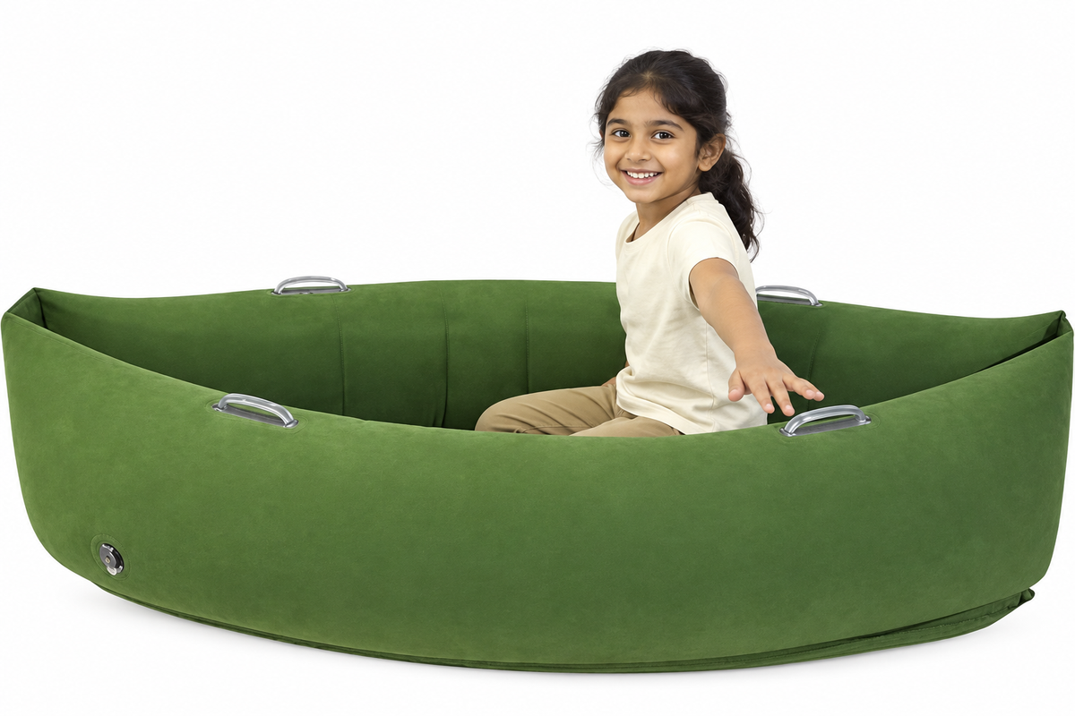 Child with tied-back hair in green sensory peapod