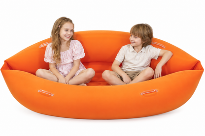 Children seated in relaxed positions inside the orange peapod