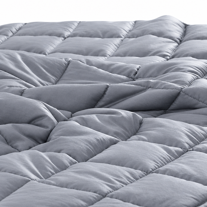 Gray quilted blanket close-up on white