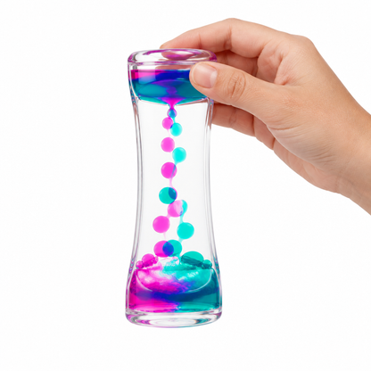 Hand tilting the liquid motion timer so the two-color droplets flow, white background, no text