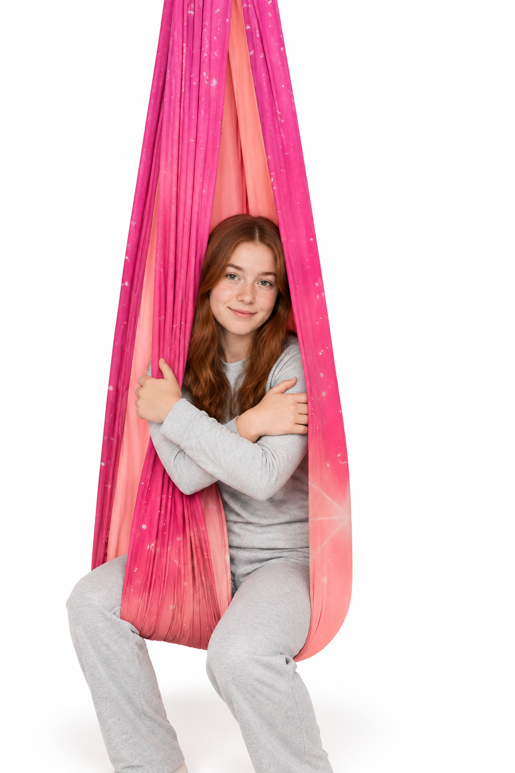 Irish teenager in the pink-and-coral sensory swing on a white background