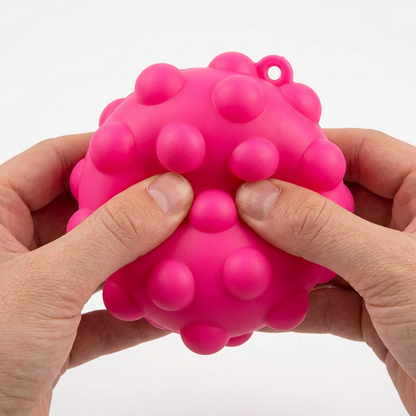 Pink ball, adult hands squeezing