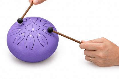 Purple drum played with mallets on white