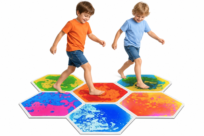 Two boys playing on hexagonal liquid sensory mats